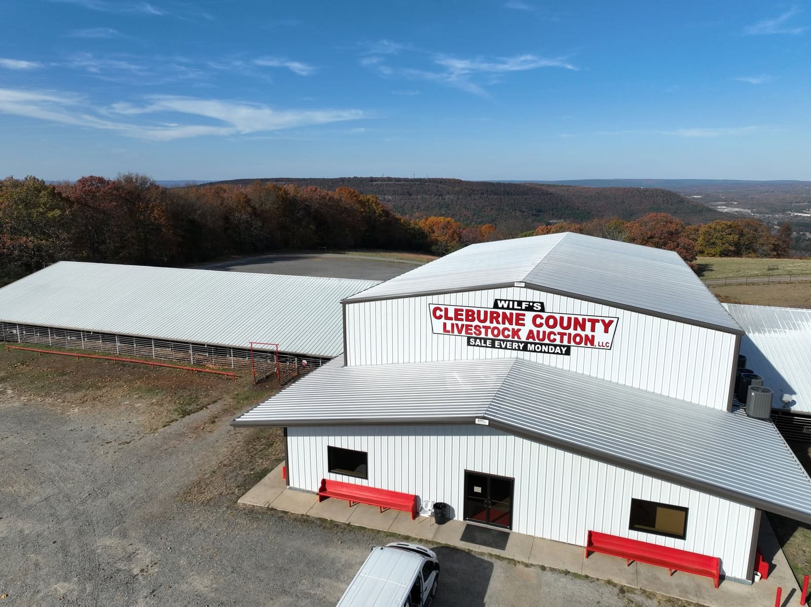 Aerial view of Wilf's Cleburne County Livestock Auction with the Ozark hills behind it